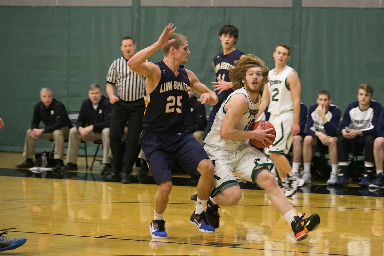 A men's basketball player looks for an opportunity to pass the ball